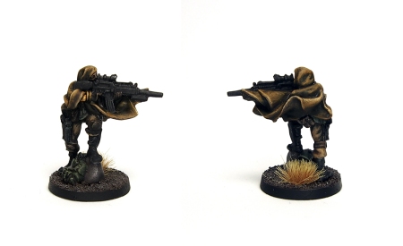 Photo of miniature with assault rifle, dressed in a cloak. Front and back views.
